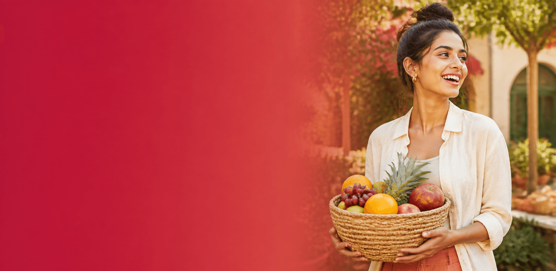 A joyful woman holding a basket of fresh fruit